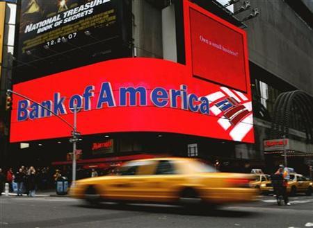 A taxi speeds past a Bank of America branch in New York's Times Square